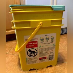 empty plastic bucket with handle and cover yellow green